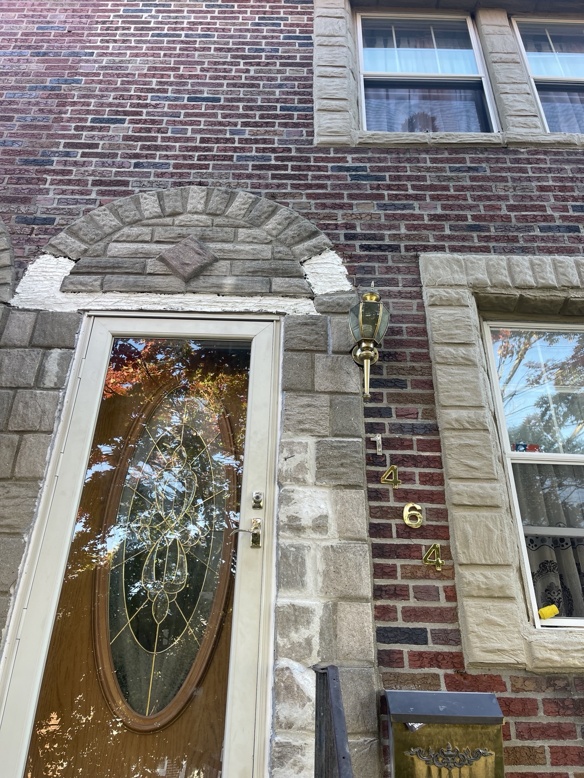 Damaged and missing textured brick face above an exterior door
