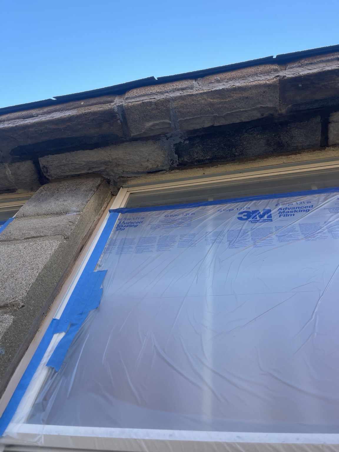 Replacement brick face shaped around an exterior window