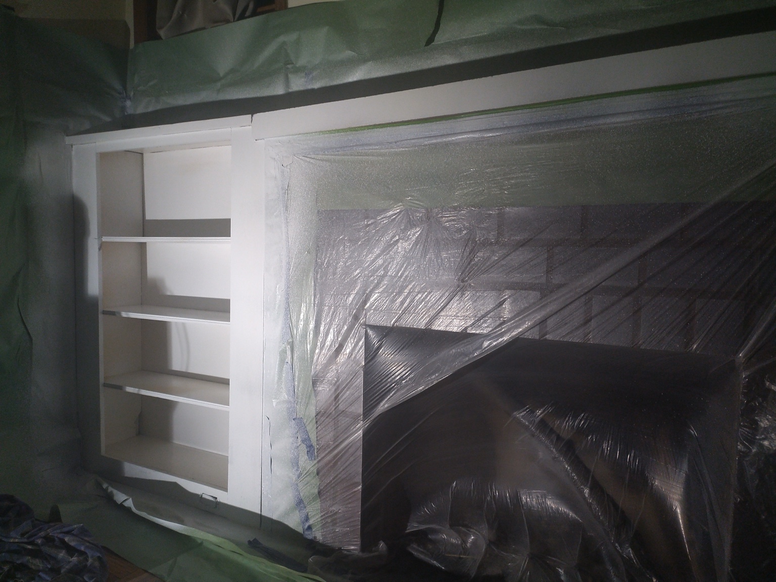New built-in shelving masked and being painted