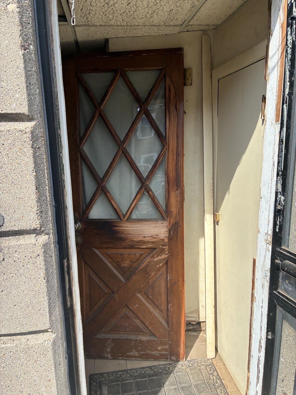 Worn original wood and glass entry door before restoration