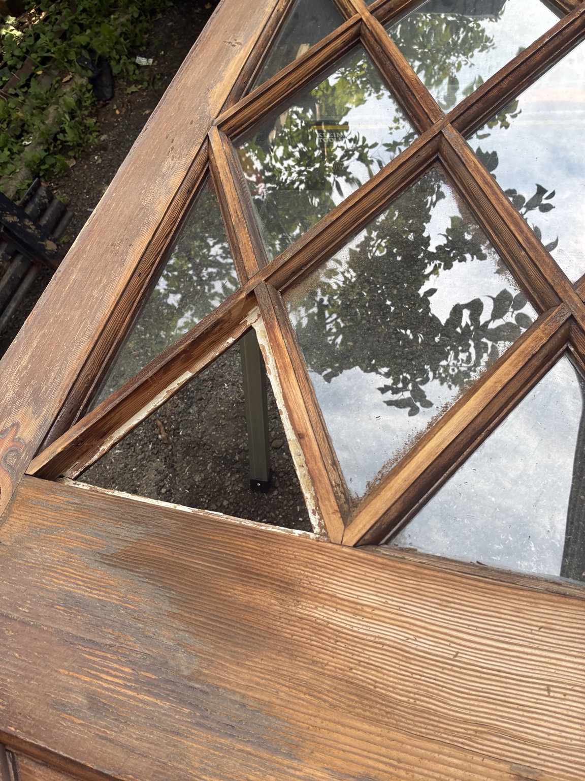 Original entry door with a missing pane of glass before repair