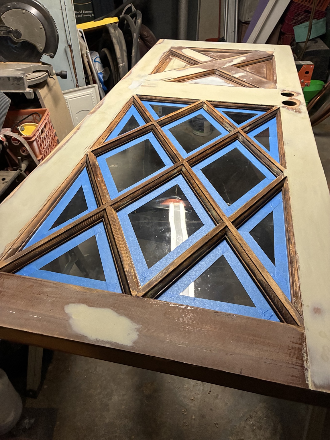 Decorative door glass masked while wood repairs are prepared