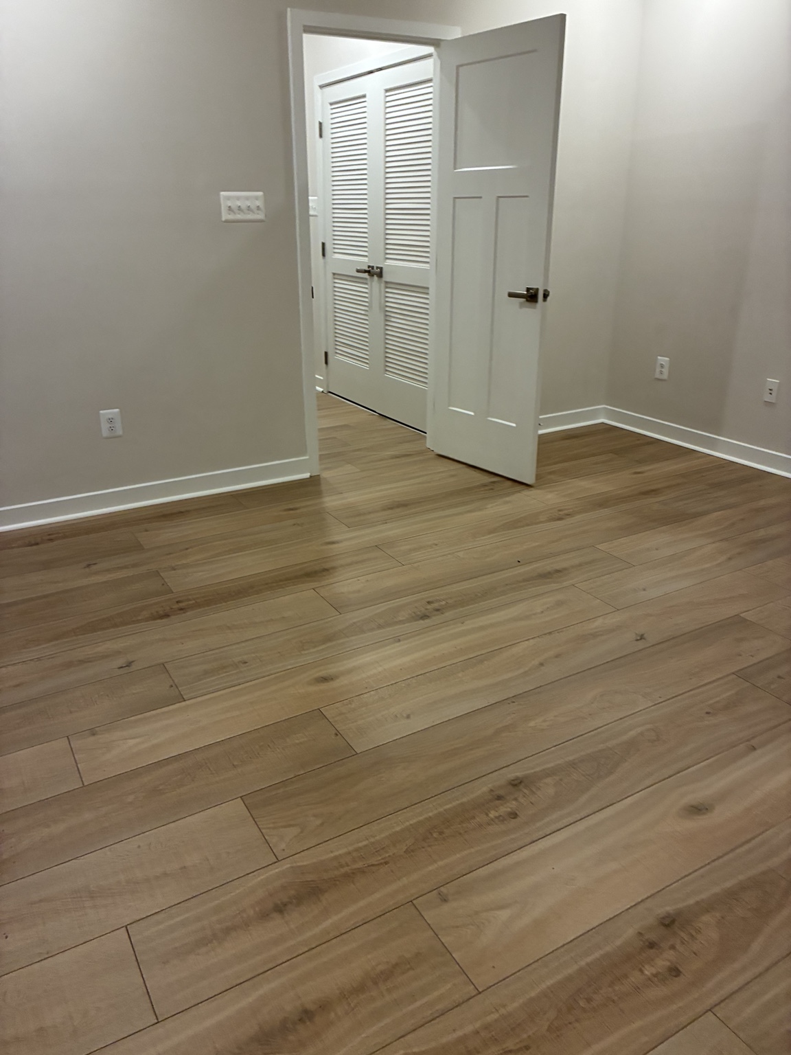 Completed light oak flooring and freshly painted trim