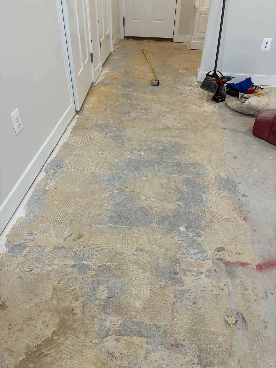 Subfloor covered in old flooring adhesive before preparation