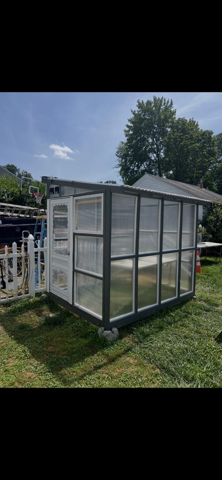 Completed custom greenhouse with decorative door