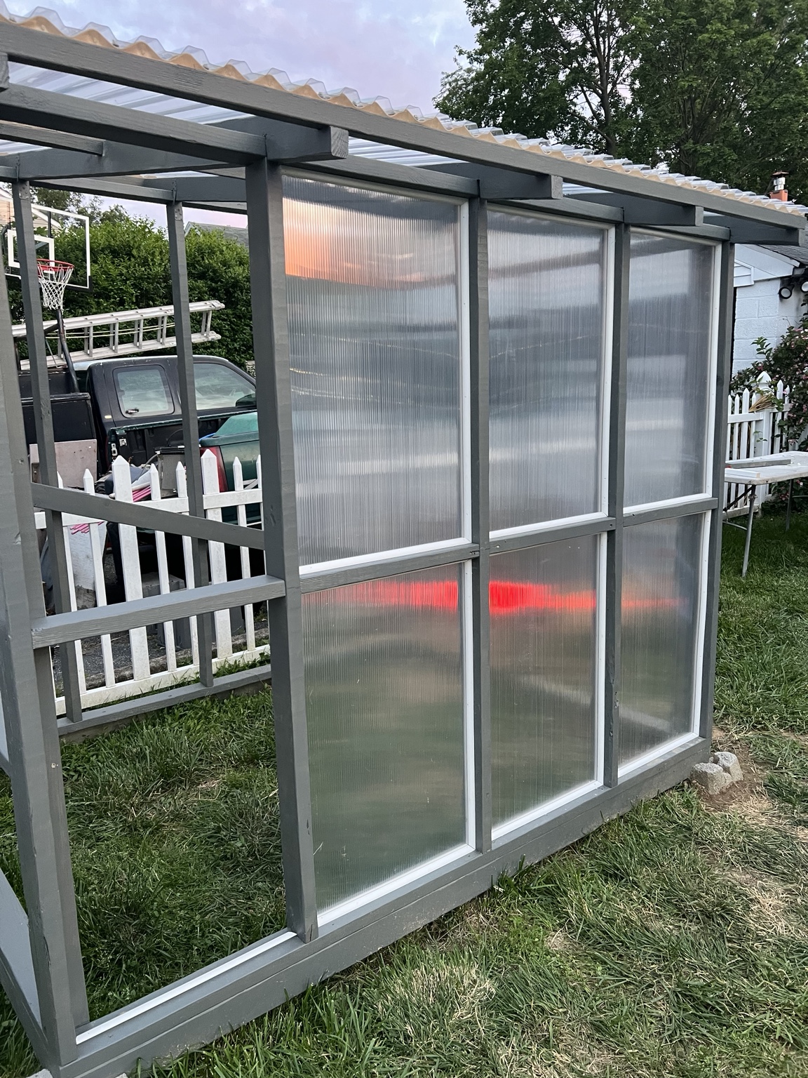 Translucent greenhouse wall panels being installed
