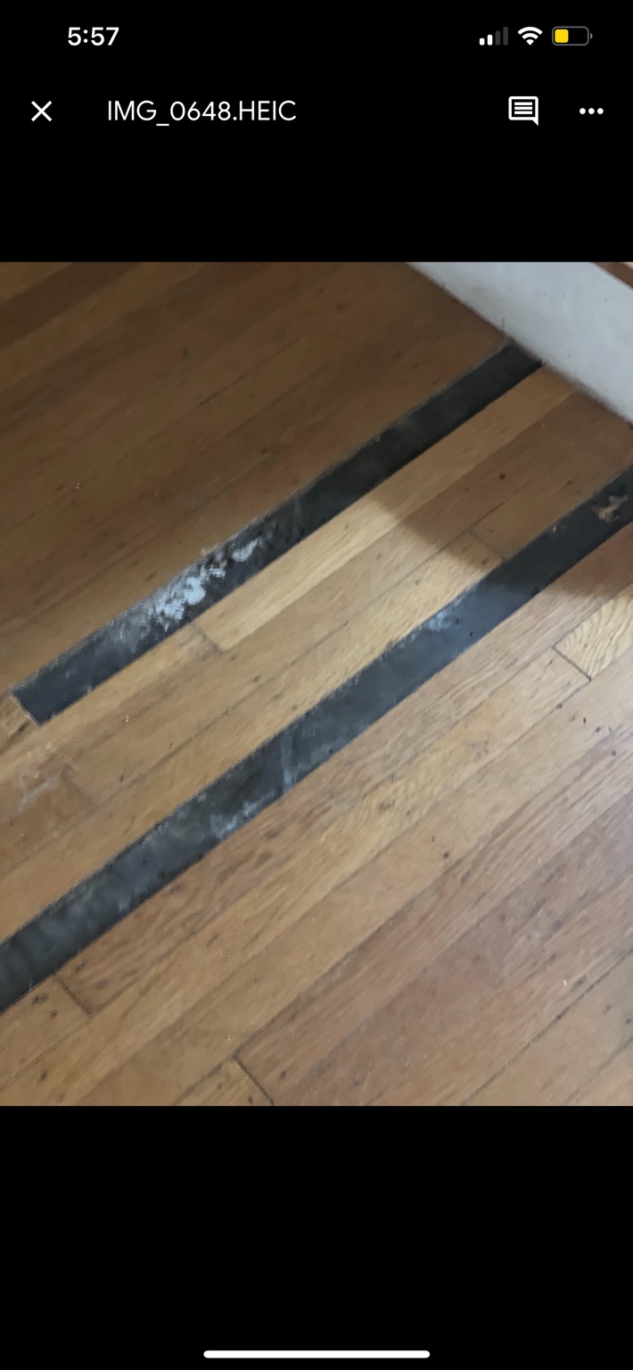 Long empty channels in an existing oak hardwood floor before repair
