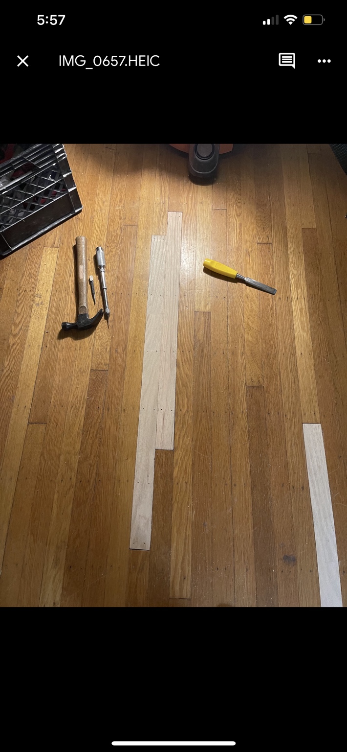 Solid oak strips ripped and cut to fit the existing hardwood floor