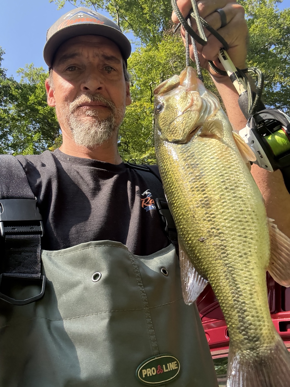 Rob Ramsay holding a large bass caught while fishing